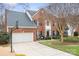 Charming two-story brick home with a well-manicured lawn and a two-car garage and basketball hoop at 215 Whitegrove Dr, Fort Mill, SC 29715
