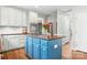 Kitchen island with cooktop, tile backsplash, stainless appliances, cabinets, and granite counters at 215 Whitegrove Dr, Fort Mill, SC 29715