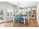 Bright eat-in kitchen with an island, granite counters, blue chairs, and stainless appliances at 215 Whitegrove Dr, Fort Mill, SC 29715