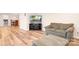 Inviting living room featuring wood floors, plush sofa, and entertainment center at 215 Whitegrove Dr, Fort Mill, SC 29715