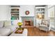 Living room showcasing a fireplace, built-in shelving, hardwood floors, and neutral furnishings at 215 Whitegrove Dr, Fort Mill, SC 29715