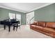 Formal living room showcasing a piano and a leather sofa with carpeted floors at 215 Whitegrove Dr, Fort Mill, SC 29715