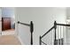 An interior staircase showcasing a wooden railing and access to a bedroom on the upper level at 215 Whitegrove Dr, Fort Mill, SC 29715