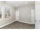 Cozy bedroom showcasing a large window, light walls, and gray wood flooring at 220 Shannonhouse W St, Shelby, NC 28152