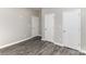 Bedroom with 3 closets, neutral walls and grey wood flooring at 220 Shannonhouse W St, Shelby, NC 28152