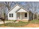 Inviting home with white siding, front porch, and a neatly kept lawn at 220 Shannonhouse W St, Shelby, NC 28152