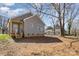 A new construction home showing the back entrance and large tree in the back yard at 220 Shannonhouse W St, Shelby, NC 28152