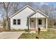Charming home with white siding, covered entry, and a well-manicured lawn at 220 Shannonhouse W St, Shelby, NC 28152