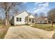 Attractive home with white siding, a concrete driveway, and mature trees at 220 Shannonhouse W St, Shelby, NC 28152
