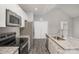 Close up on kitchen with stainless appliances, granite countertops, and gray wood floors at 220 Shannonhouse W St, Shelby, NC 28152