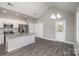 Bright kitchen with white cabinetry, granite countertops, and stainless steel refrigerator at 220 Shannonhouse W St, Shelby, NC 28152