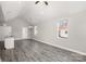 Open-concept living room featuring gray wood floors, neutral walls, and modern lighting at 220 Shannonhouse W St, Shelby, NC 28152