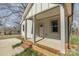 Inviting front porch featuring brick accents and covered columns at 220 Shannonhouse W St, Shelby, NC 28152