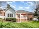 Exterior view of brick and vinyl home with a well-maintained lawn and cozy back patio at 2713 Firethorn Ct # 48, Gastonia, NC 28056