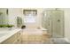 Bright bathroom with a soaking tub, glass shower, and neutral tile flooring at 2713 Firethorn Ct # 48, Gastonia, NC 28056