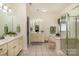 A spacious bathroom suite with double vanity, bathtub, shower, and neutral decor at 2713 Firethorn Ct # 48, Gastonia, NC 28056