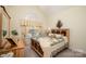 Comfortable bedroom featuring a decorative headboard, patterned bedding, and natural light at 2713 Firethorn Ct # 48, Gastonia, NC 28056