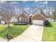 Charming brick home with a manicured lawn, long driveway, and attached two-car garage at 2713 Firethorn Ct # 48, Gastonia, NC 28056