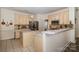 A partial shot of a spacious kitchen showing the double islands, sink, range, microwave, and stainless refrigerator at 2713 Firethorn Ct # 48, Gastonia, NC 28056