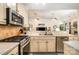 Functional kitchen with gas range, tile backsplash, and an open view to the living space at 2713 Firethorn Ct # 48, Gastonia, NC 28056