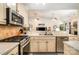 Well-lit kitchen featuring stainless steel appliances and seamless view into the living room at 2713 Firethorn Ct # 48, Gastonia, NC 28056