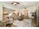 Open living room with plush seating, neutral decor, and view of the adjacent kitchen area at 2713 Firethorn Ct # 48, Gastonia, NC 28056