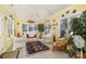 A spacious sunroom with tile floor, ceiling fan, lots of windows, and wicker furniture at 2713 Firethorn Ct # 48, Gastonia, NC 28056