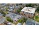 Aerial view of the apartments, surrounding houses, and a spacious parking lot with multiple cars at 300 N Fulton St # 12, Salisbury, NC 28144