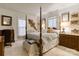 Spacious bedroom with four poster bed, hardwood floors, and natural light at 300 N Fulton St # 12, Salisbury, NC 28144