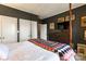 Well-lit bedroom with a four-poster bed, TV, and classic dresser against dark gray walls at 300 N Fulton St # 12, Salisbury, NC 28144