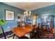 Another view of the formal dining room with a crystal chandelier and blue walls at 300 N Fulton St # 12, Salisbury, NC 28144