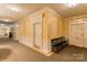 Hallway with yellow walls, carpet, white trim, and a bench against the right wall at 300 N Fulton St # 12, Salisbury, NC 28144