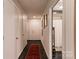 Long hallway with closed white doors and a red decorative rug running down the center at 300 N Fulton St # 12, Salisbury, NC 28144