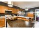 Cozy kitchen with dark accent wall, wood cabinets, and a rustic wooden island with an eating area at 300 N Fulton St # 12, Salisbury, NC 28144