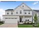 Beautiful two-story home featuring stone accents, a two-car garage and manicured landscaping at 3022 Bramble Hedge Rd # 3269, Indian Trail, NC 28079