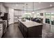 Spacious kitchen with an island and sleek appliances, flowing into a bright dining area at 3022 Bramble Hedge Rd # 3269, Indian Trail, NC 28079