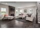 Cozy living room featuring a stone fireplace, hardwood floors, and comfortable seating arrangement at 3022 Bramble Hedge Rd # 3269, Indian Trail, NC 28079