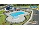 Aerial view of a community pool with lounge chairs, playground, parking, and landscaping at 3022 Bramble Hedge Rd # 3269, Indian Trail, NC 28079