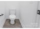 A modern bathroom featuring a white toilet and gray tiled floors at 3030 Swallowtail Ln, Kannapolis, NC 28083