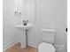 Contemporary bathroom with a pedestal sink, toilet, and a large mirror at 3030 Swallowtail Ln, Kannapolis, NC 28083