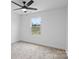 A bright bedroom features neutral walls, carpet, a ceiling fan, and a window at 3030 Swallowtail Ln, Kannapolis, NC 28083