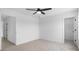 Bright bedroom featuring neutral carpet, a ceiling fan, and two doorways at 3030 Swallowtail Ln, Kannapolis, NC 28083