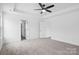 Spacious bedroom featuring a tray ceiling, ceiling fan, and neutral carpet at 3030 Swallowtail Ln, Kannapolis, NC 28083