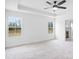 Bright bedroom featuring neutral carpet, two windows, and an ensuite bath at 3030 Swallowtail Ln, Kannapolis, NC 28083
