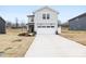 Charming two-story home featuring a white garage door, stone accents and a long driveway at 3030 Swallowtail Ln, Kannapolis, NC 28083