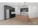 Modern kitchen featuring sleek black cabinets, stainless steel appliances, and a center island at 3030 Swallowtail Ln, Kannapolis, NC 28083