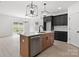 Modern kitchen with wood cabinets, stainless steel dishwasher, and a bright white countertop at 3030 Swallowtail Ln, Kannapolis, NC 28083