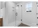 Modern glass enclosed shower with white tile and black fixtures at 3030 Swallowtail Ln, Kannapolis, NC 28083