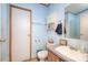 Functional bathroom featuring blue walls, a vanity, and a cabinet providing a clean and practical space at 355 Branchwood Rd, Statesville, NC 28625