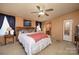 Cozy bedroom with wood-trimmed headboard and ceiling fan, offering a peaceful retreat at 355 Branchwood Rd, Statesville, NC 28625